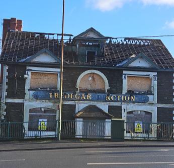 An abandoned pub with a collapsed roof